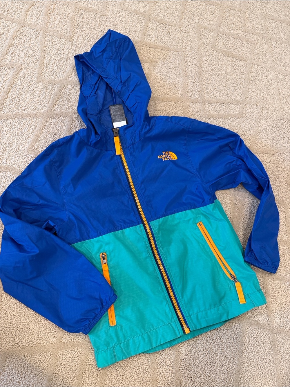 The North Face Kids Blue and Teal Colorblock Raincoat with Yellow Accents